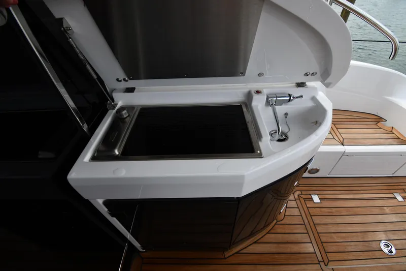 Slide: The Image of Outdoor kitchen area on 2024 Fairline G50 Targa yacht with grill and sink. - 14