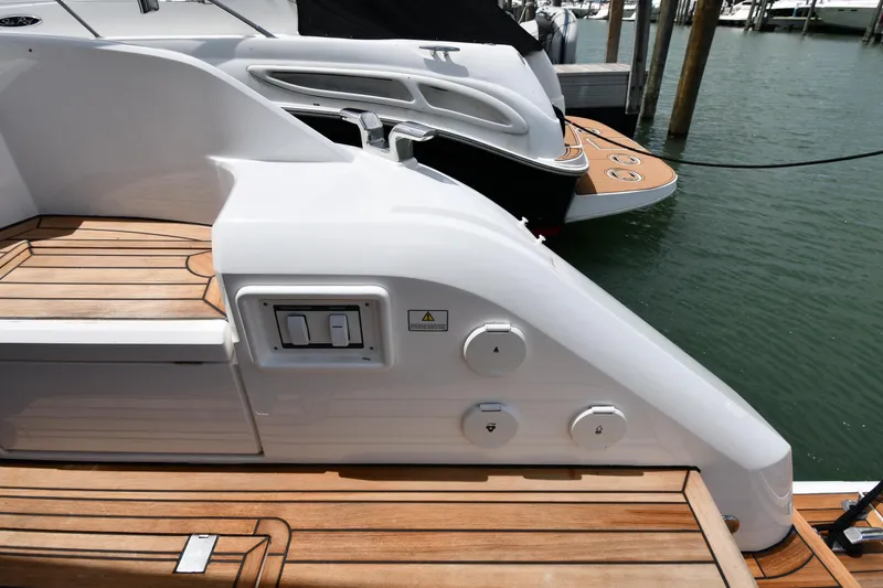 Slide: The Image of 2024 Fairline G50 Targa yacht with sleek design and wooden deck at marina. - 15