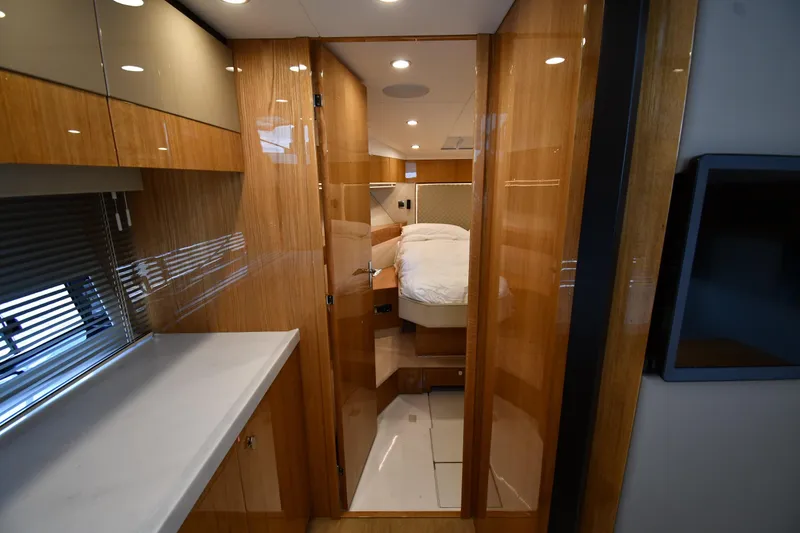 Slide: The Image of Luxurious interior of 2024 Fairline G50 Targa yacht, featuring sleek wood finishes and modern design. - 18