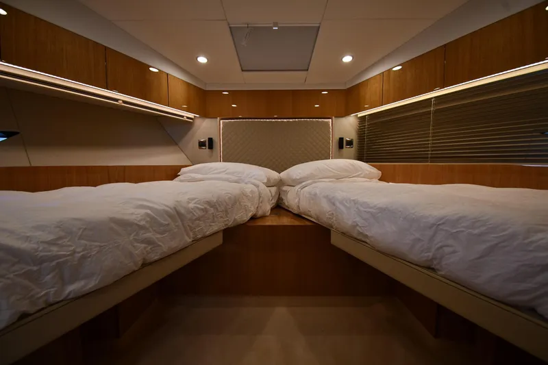 Slide: The Image of Luxurious twin cabin interior of 2024 Fairline G50 Targa yacht, featuring modern wood finishes. - 20