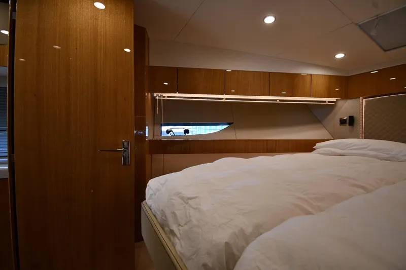 Slide: The Image of Luxurious bedroom interior of 2024 Fairline G50 Targa yacht with wood paneling. - 22