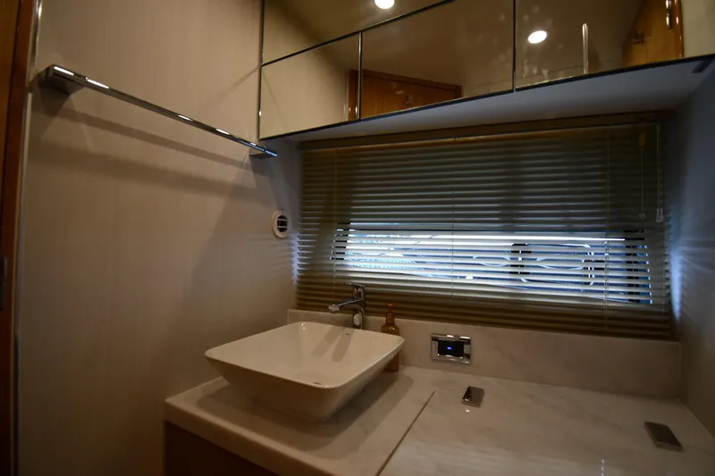 Slide: The Image of Luxurious bathroom interior of 2024 Fairline G50 Targa yacht with modern sink and blinds. - 28