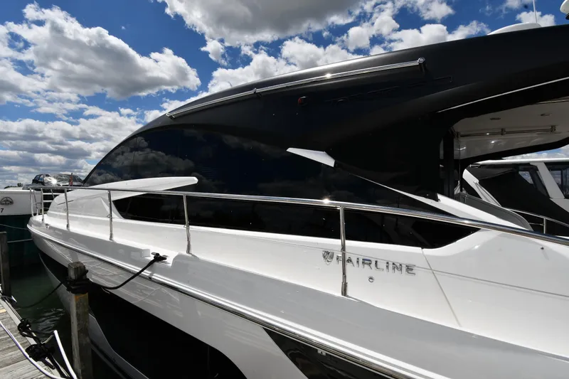 Slide: The Image of 2024 Fairline G50 Targa yacht docked under a partly cloudy sky. - 3