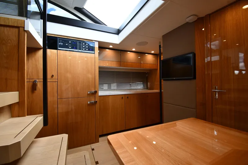 Slide: The Image of 2024 Fairline G50 Targa yacht interior with modern wood finish and sleek design. - 31