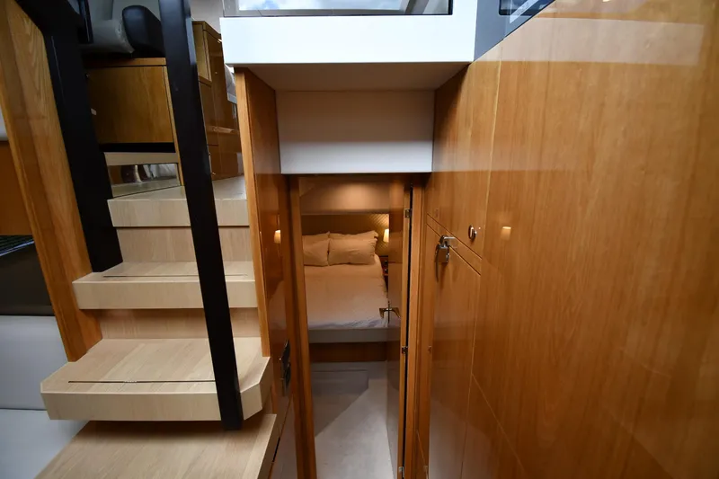 Slide: The Image of 2024 Fairline G50 Targa yacht interior with wooden stairs and cozy bedroom. - 37