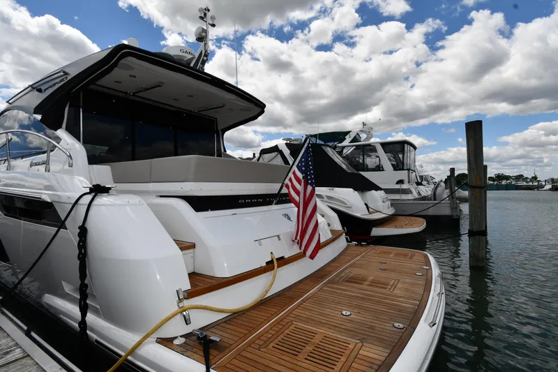 Slide: The Image of 2024 Fairline G50 Targa yacht docked, featuring sleek design and American flag. - 4