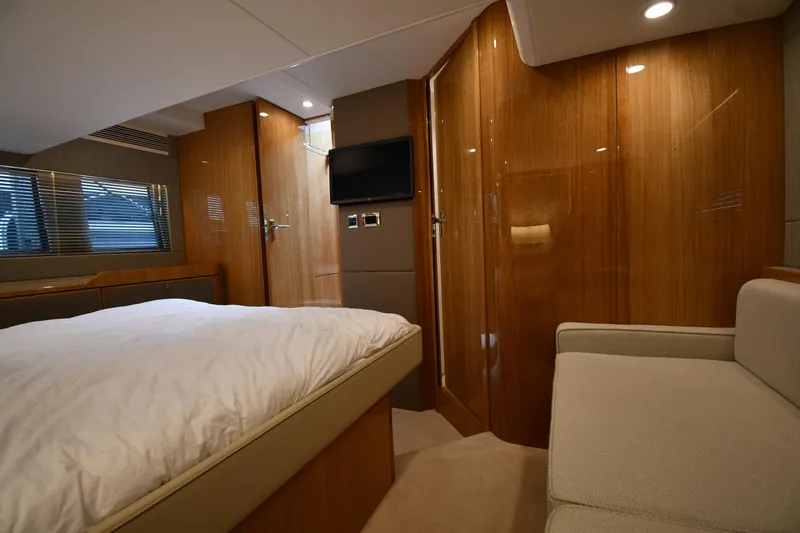 Slide: The Image of Luxurious cabin interior of 2024 Fairline G50 Targa yacht with wood paneling and modern amenities. - 41