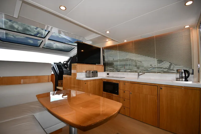 Slide: The Image of Luxurious interior of 2024 Fairline G50 Targa yacht with modern kitchen and seating area. - 45