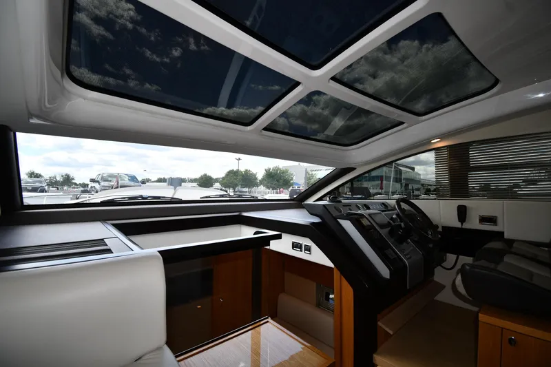 Slide: The Image of Interior view of 2024 Fairline G50 Targa yacht cockpit with panoramic sunroof. - 49