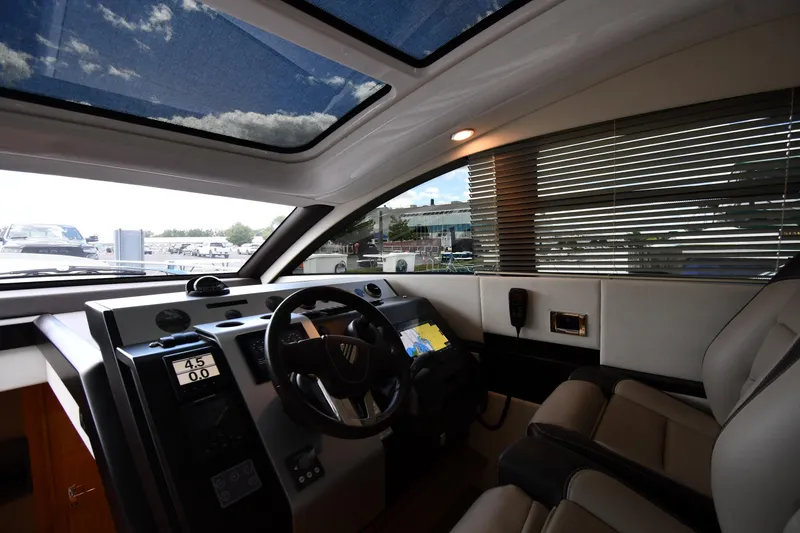 Slide: The Image of Interior cockpit of 2024 Fairline G50 Targa yacht with modern controls and panoramic windows. - 50