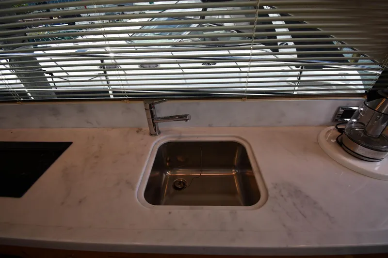 Slide: The Image of Modern kitchen sink in 2024 Fairline G50 Targa yacht with marble countertop. - 57
