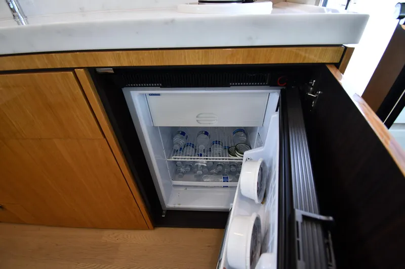 Slide: The Image of Mini fridge in 2024 Fairline G50 Targa yacht kitchen, stocked with bottled water. - 60