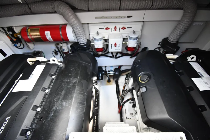 Slide: The Image of Engine room of 2024 Fairline G50 Targa yacht, featuring Volvo engines and safety equipment. - 64