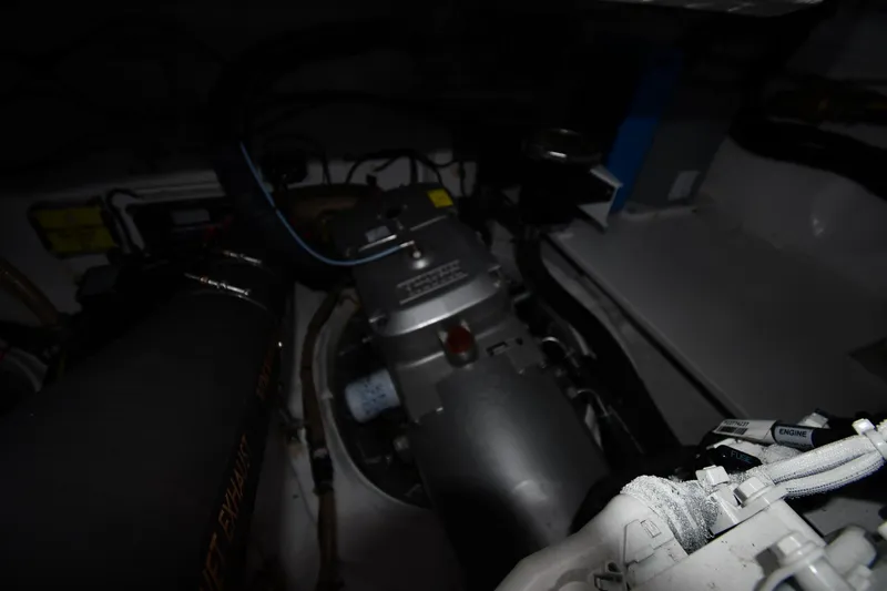 Slide: The Image of Engine compartment of 2024 Fairline G50 Targa yacht, showcasing mechanical components and wiring. - 66