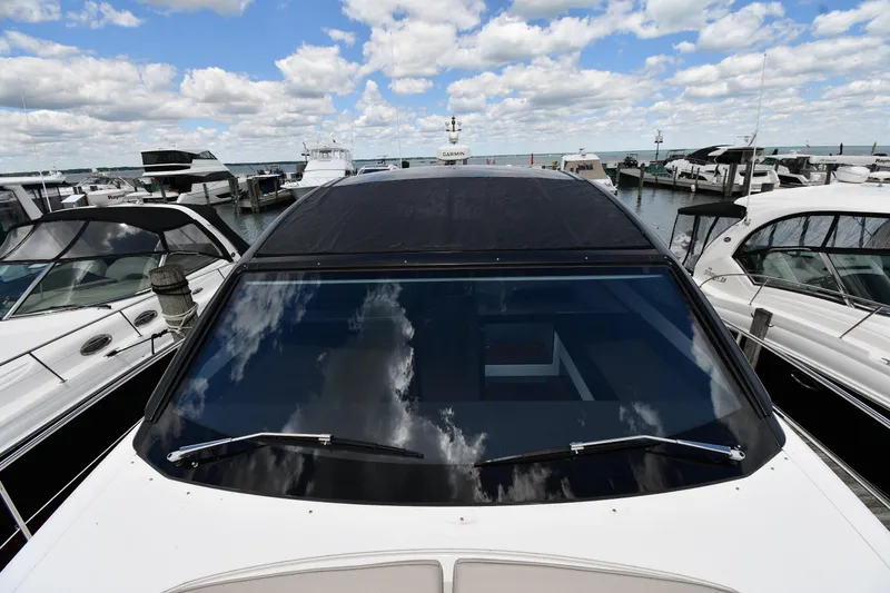Slide: The Image of 2024 Fairline G50 Targa yacht docked at marina under partly cloudy sky. - 9