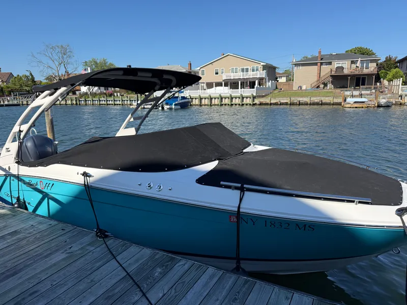 The Image of 2022 Regal LX4 boat docked on calm water. - 0