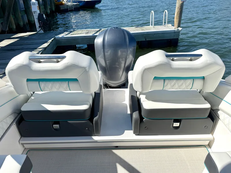 Slide: The Image of Interior of a 2022 Regal LX4 boat by the water. - 12