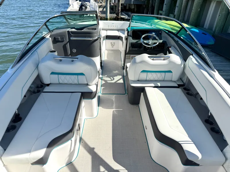 Slide: The Image of Interior of a 2022 Regal LX4 boat on the water. - 13