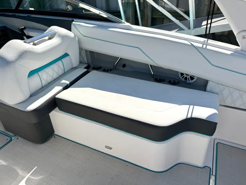 Slide: The Image of Regal LX4 2022 boat with open storage compartment and seating area. - 19