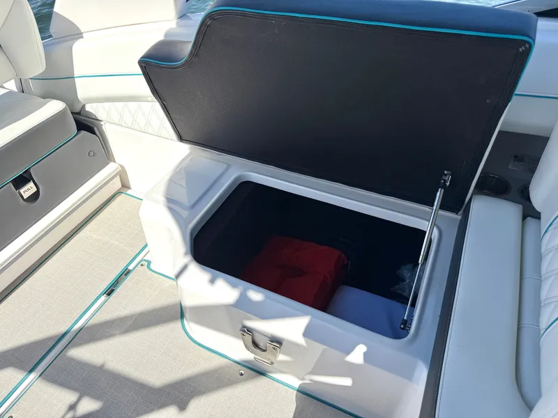 Slide: The Image of Regal LX4 2022 boat with Igloo cooler in storage compartment. - 21