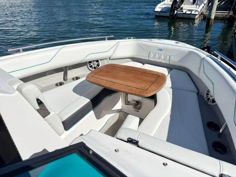 Slide: The Image of Interior of a 2022 Regal LX4 boat with wooden table. - 29