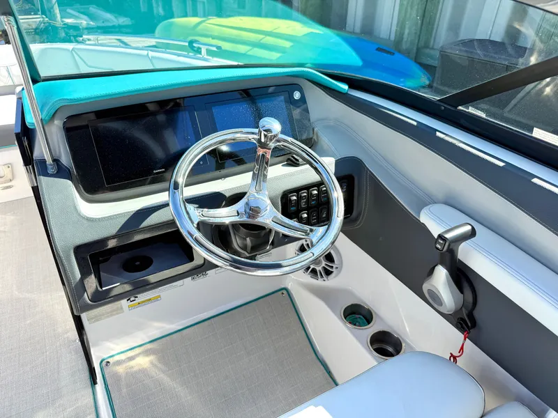 Slide: The Image of Helm of 2022 Regal LX4 boat with steering wheel and instruments. - 3