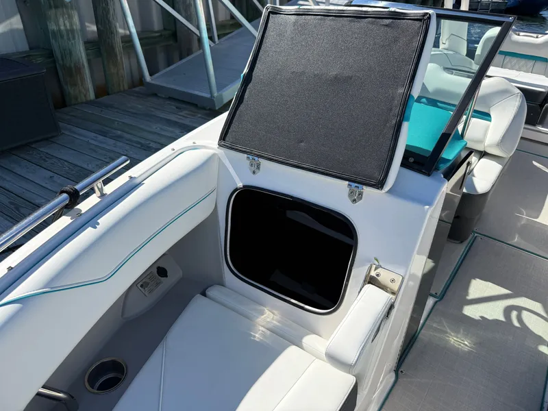 Slide: The Image of Regal LX4 2022 boat with open storage compartment and seating area. - 33