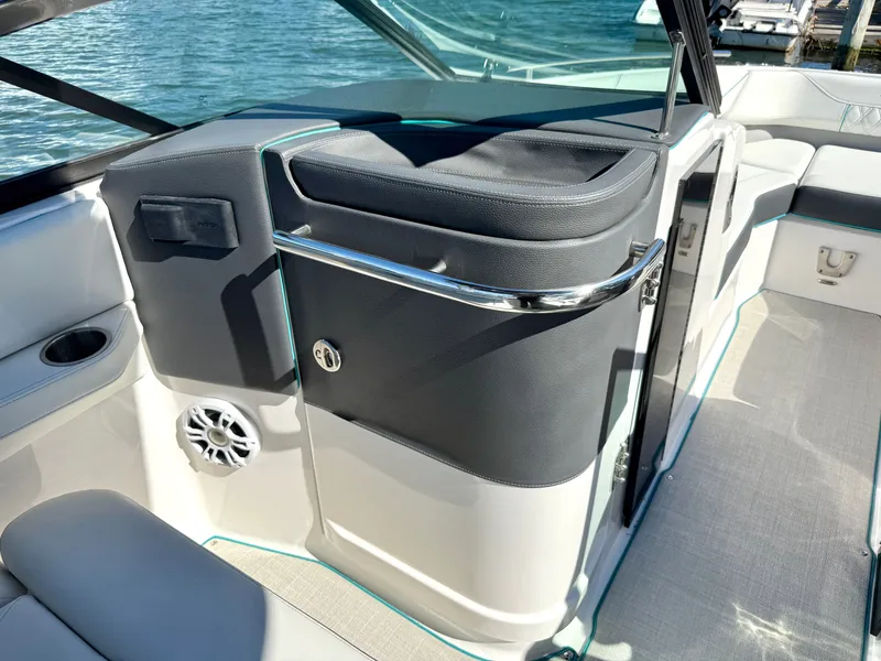Slide: The Image of Interior of a 2022 Regal LX4 boat by the water. - 34