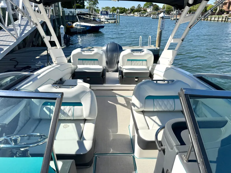 Slide: The Image of Interior of a 2022 Regal LX4 boat on the water. - 36