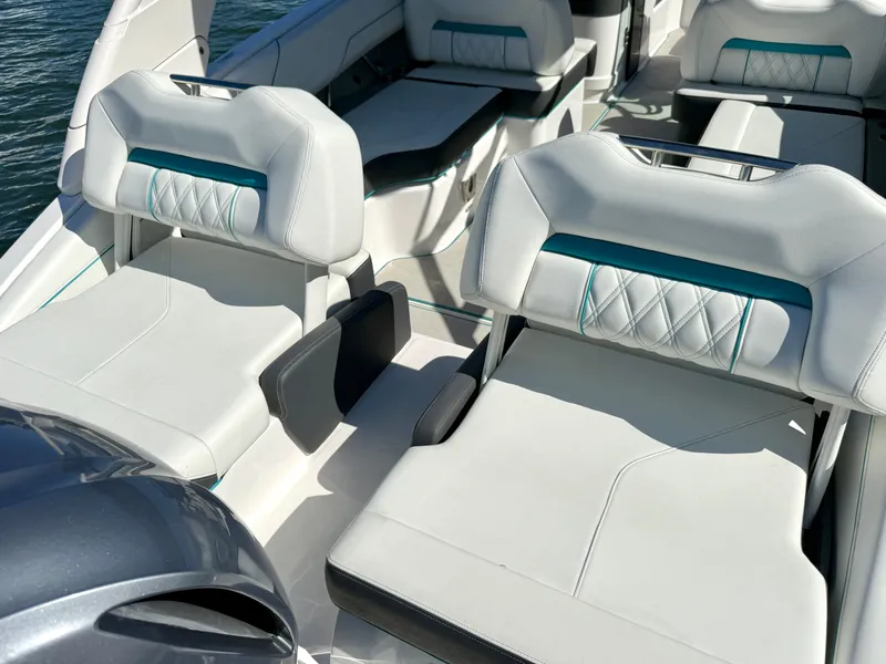 Slide: The Image of 2022 Regal LX4 boat with open storage compartments on water. - 8