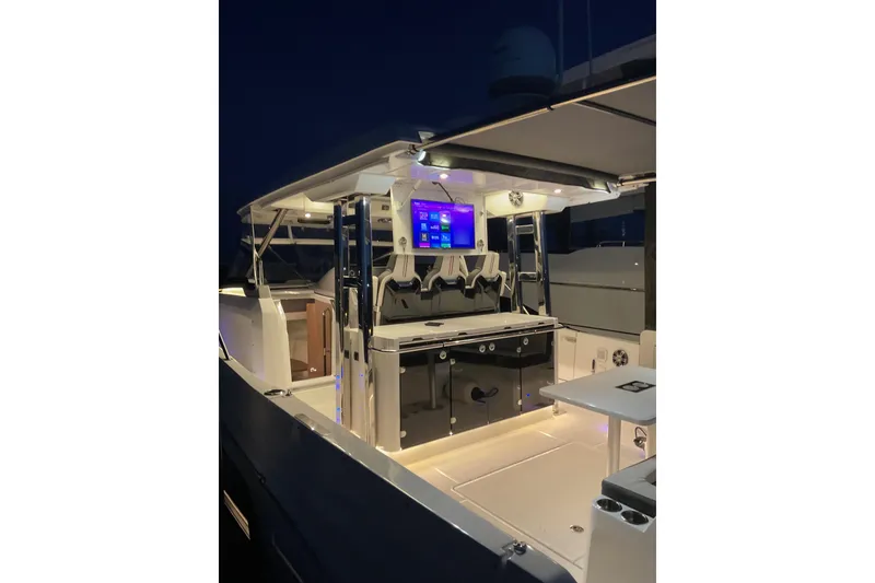 Slide: The Image of 2021 Jeanneau Leader 12.5 WA boat interior with illuminated seating and modern amenities. - 14