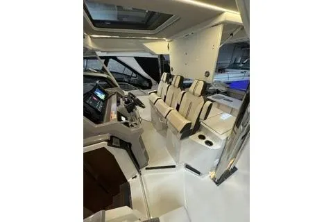 Slide: The Image of Interior of 2021 Jeanneau Leader 12.5 WA boat with modern seating and control panel. - 21