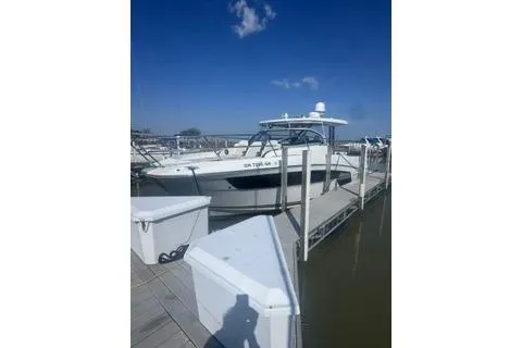 Slide: The Image of 2021 Jeanneau Leader 12.5 WA docked under clear blue sky. - 3