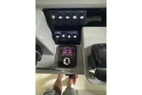 Slide: The Image of Control panel of 2021 Jeanneau Leader 12.5 WA boat with illuminated switches and navigation display. - 40