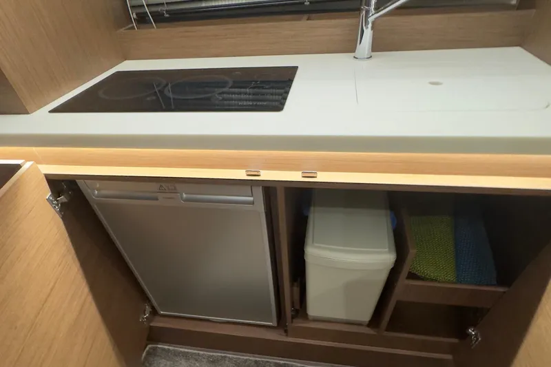 Slide: The Image of Modern kitchenette in 2021 Jeanneau Leader 12.5 WA boat with stove, sink, and storage. - 35