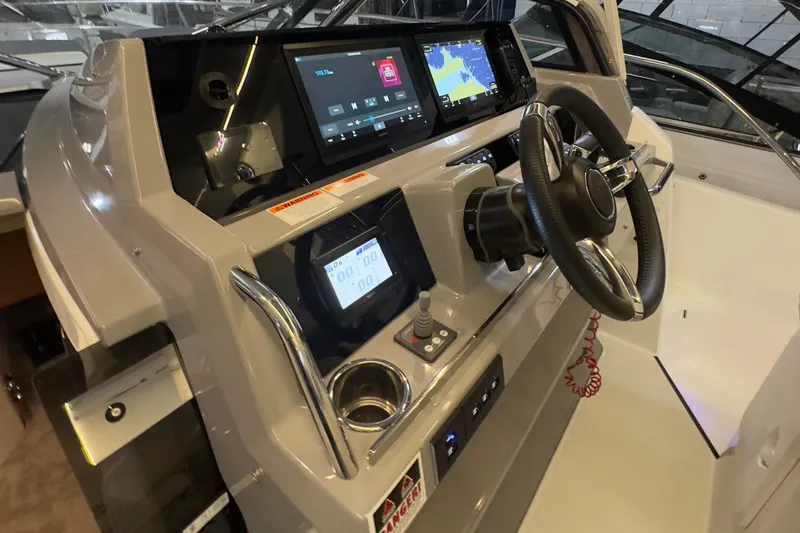 Slide: The Image of Cockpit of 2021 Jeanneau Leader 12.5 WA with modern navigation displays and steering wheel. - 22