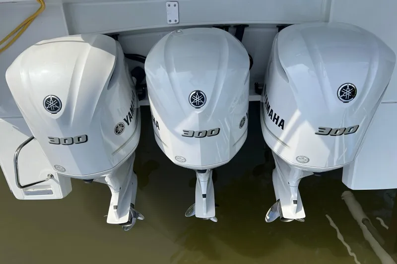 Slide: The Image of Triple Yamaha 300 outboard engines on a 2021 Jeanneau Leader 12.5 WA boat. - 27