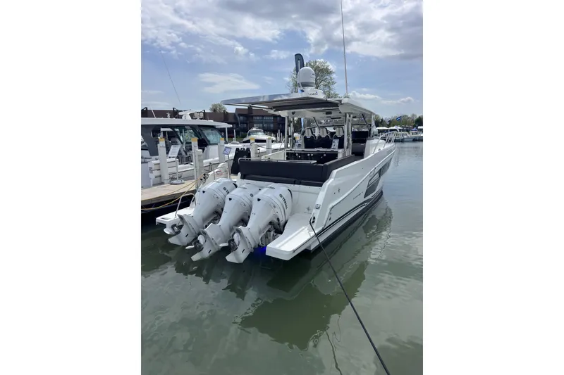 Slide: The Image of 2021 Jeanneau Leader 12.5 WA boat docked with triple outboard engines. - 4