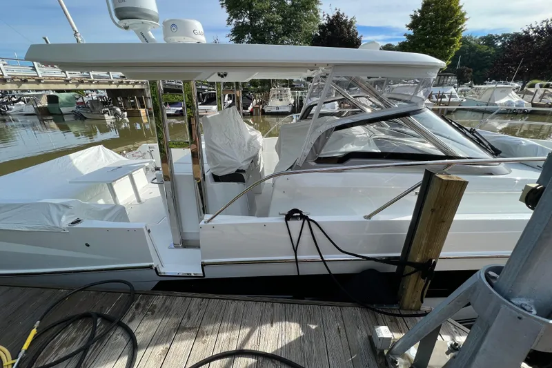 Slide: The Image of 2021 Jeanneau Leader 12.5 WA docked at a marina, showcasing sleek design and modern features. - 7