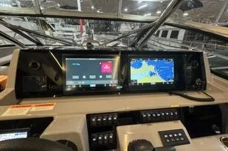 Slide: The Image of 2021 Jeanneau Leader 12.5 WA dashboard with navigation screens and controls. - 16