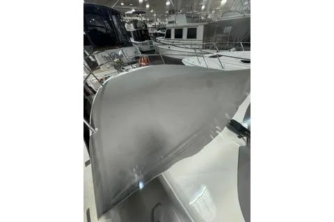 Slide: The Image of 2021 Jeanneau Leader 12.5 WA boat showcased at a marina, featuring sleek design. - 8