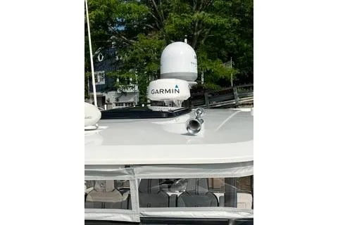Slide: The Image of 2021 Jeanneau Leader 12.5 WA boat with Garmin radar, docked near trees. - 37
