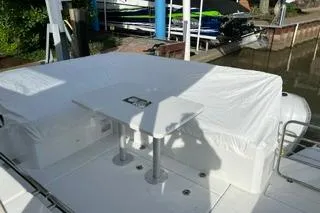 Slide: The Image of 2021 Jeanneau Leader 12.5 WA boat deck with covered seating and table. - 26