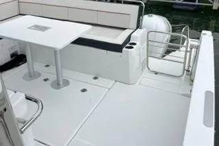 Slide: The Image of 2021 Jeanneau Leader 12.5 WA boat deck with seating and table. - 25