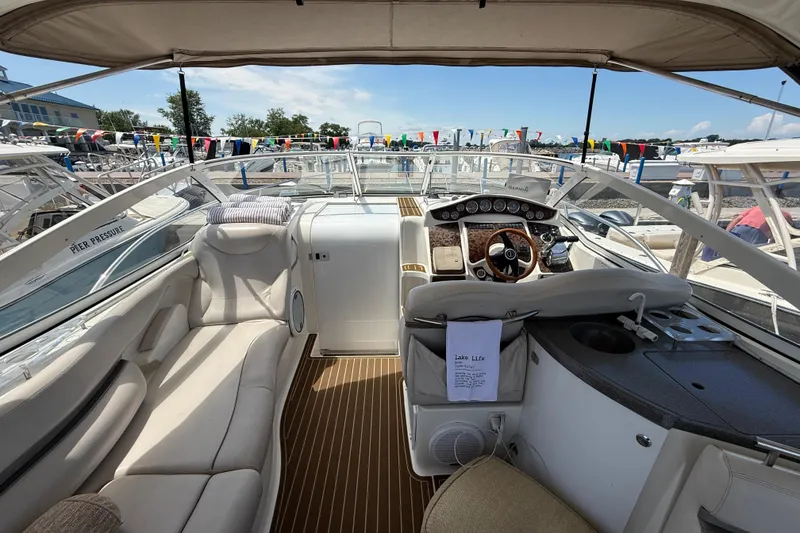 Slide: The Image of Interior view of a 2001 Doral 330se boat with luxurious seating and control panel. - 10