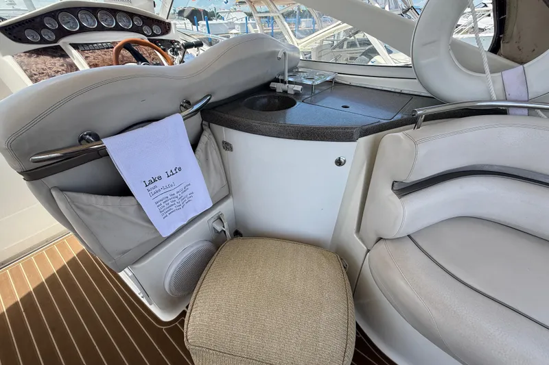Slide: The Image of Interior of a 2001 Doral 330se boat with seating and helm. - 11