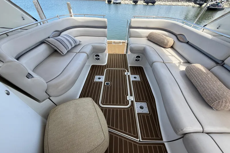 Slide: The Image of Luxurious seating area on a 2001 Doral 330se yacht with elegant cushions and wood flooring. - 12