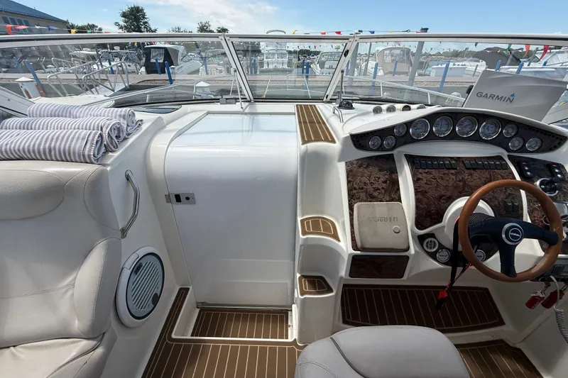 Slide: The Image of Interior of a 2001 Doral 330se boat with a modern dashboard and striped towels. - 13