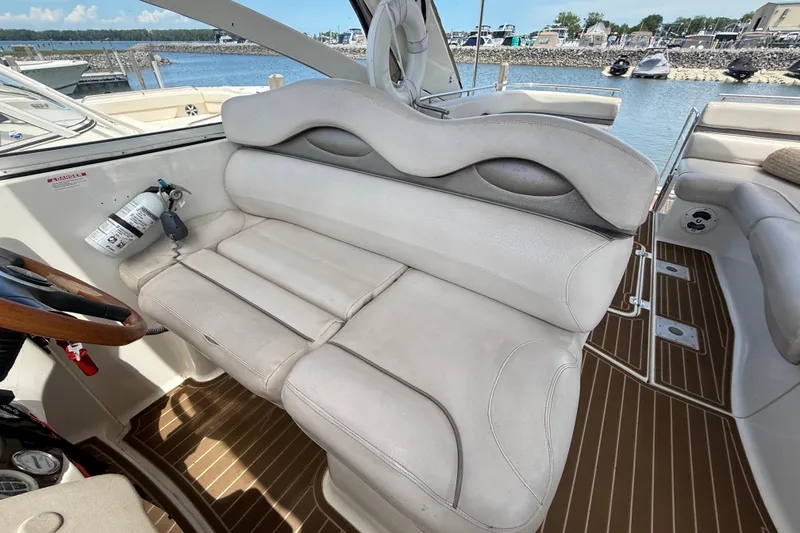 Slide: The Image of Interior of a 2001 Doral 330se boat with beige seating and wooden accents. - 14