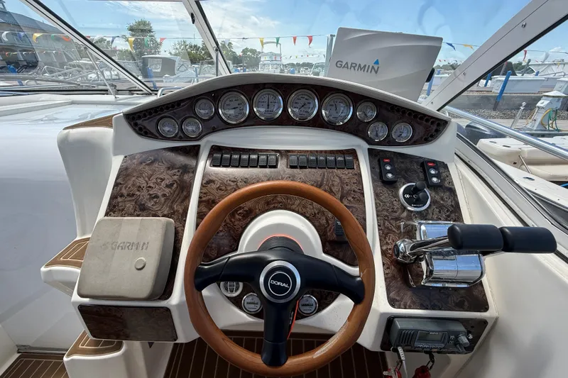 Slide: The Image of Cockpit of a 2001 Doral 330se boat with Garmin navigation system and wood-accented steering wheel. - 15